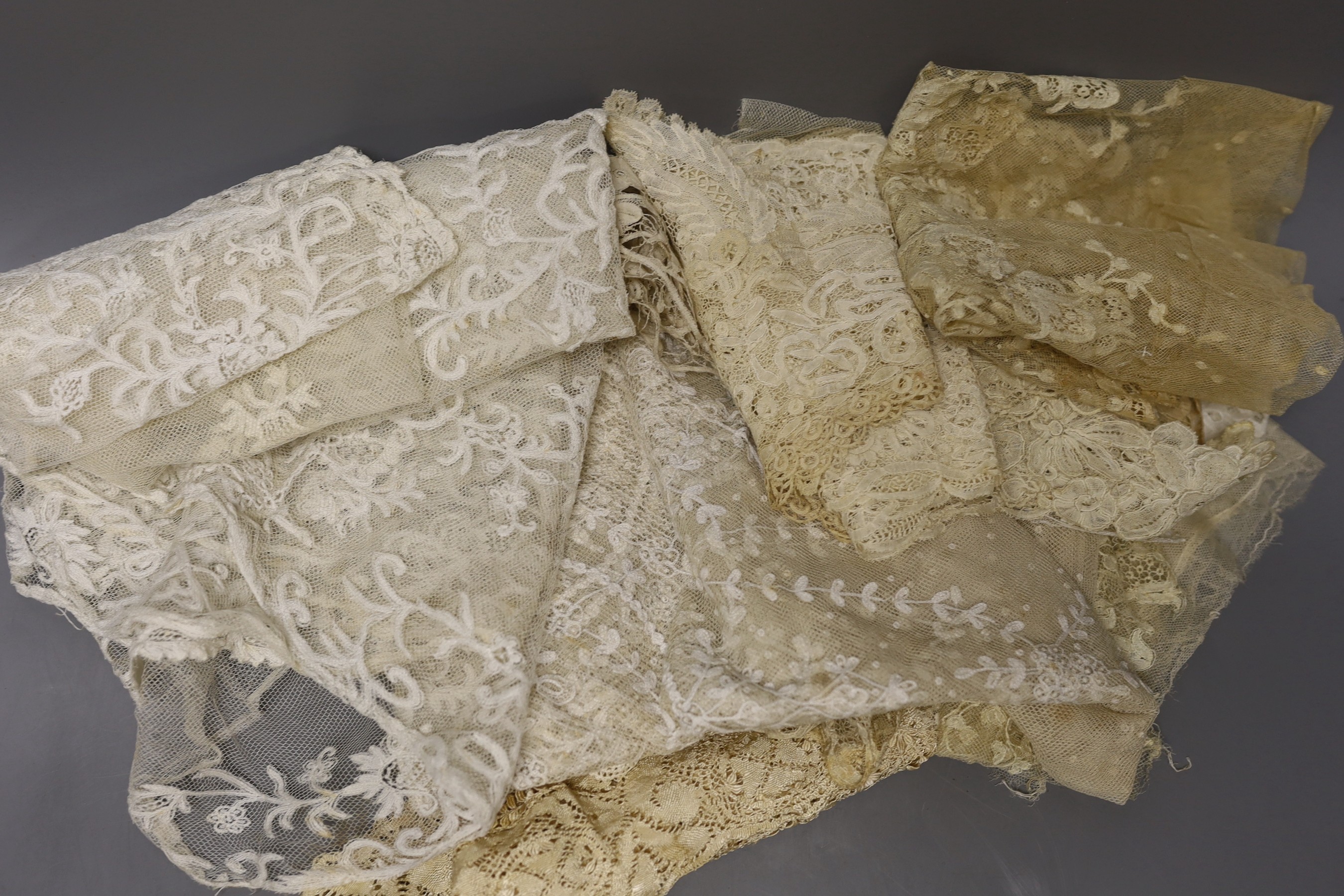 A collection of 19th century hand made Honiton bobbin lace collars, trim etc and various needle run bonnet veils, a Maltese silk lace panel together with other lace.